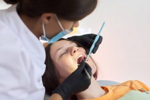 dentist performs treatment on sedated patient