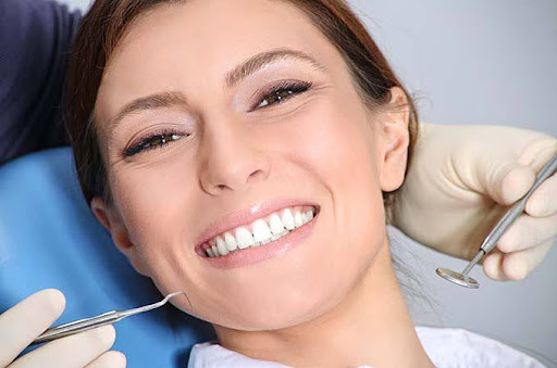 patient smiles in dental chair